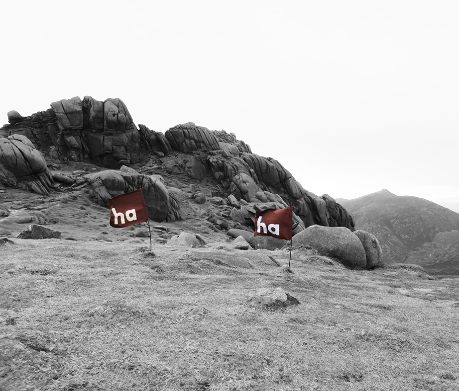 Image of two 'ha ha' flags on the summit of Bearnagh Mountain - displaying 'ha ha' clearly